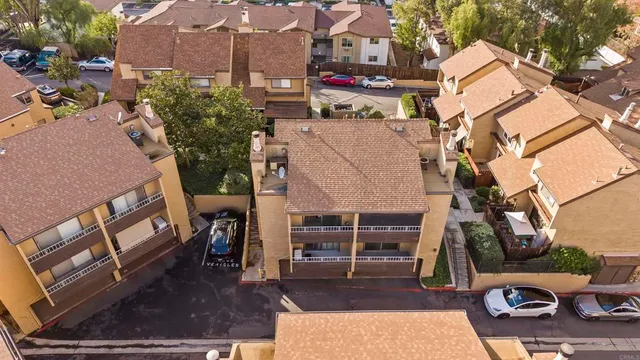 an aerial view of residential houses with outdoor space