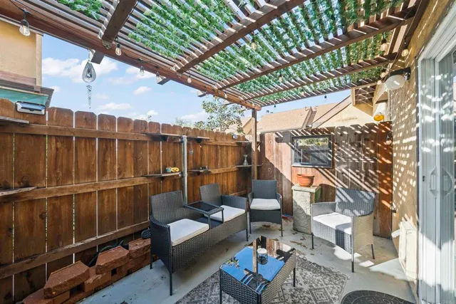 a view of a house with a yard and sitting area