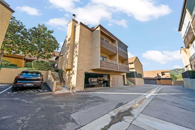 a view of a patio with a table chairs and a garden