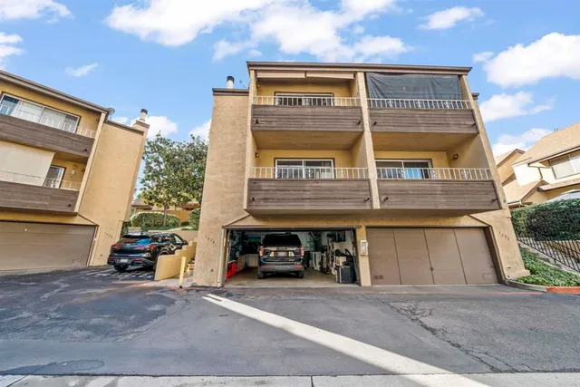 an aerial view of multiple houses with yard