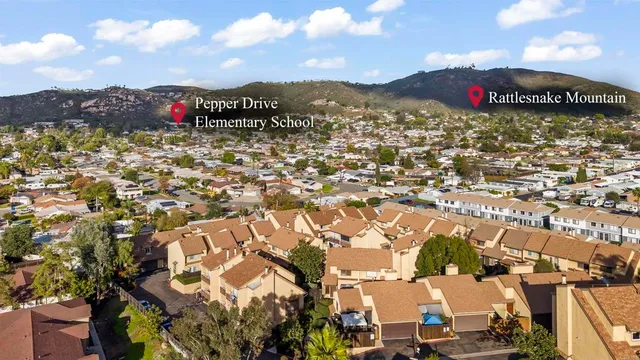 an aerial view of residential building with outdoor space and trees