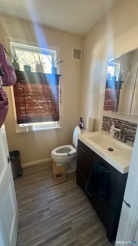 a bathroom with a sink toilet a mirror and shower