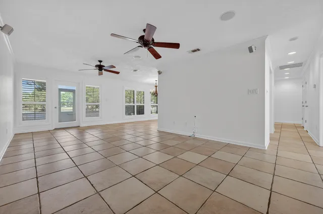 a view of a kitchen with a sink and an empty room