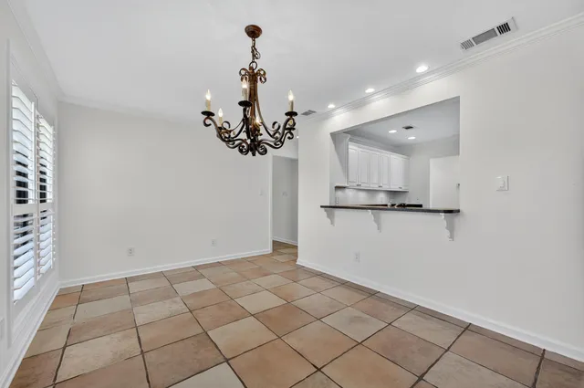 a kitchen with a sink window and cabinets