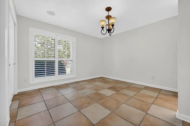 a bathroom with a granite countertop sink a toilet and mirror