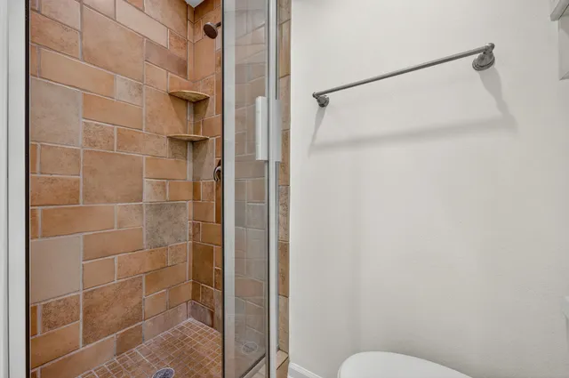 an aerial view of residential houses with outdoor space and swimming pool