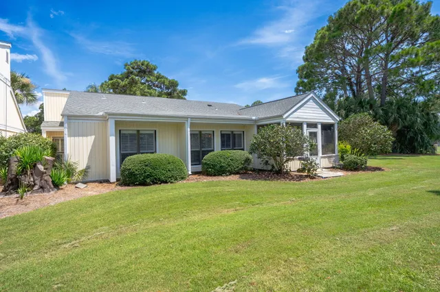 an aerial view of residential houses with outdoor space and trees