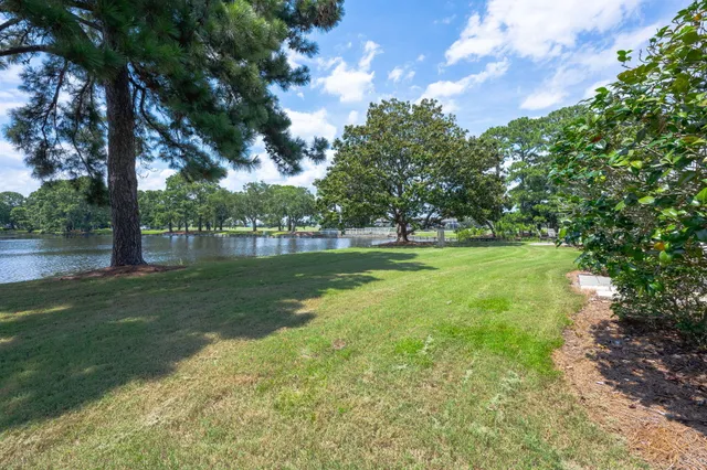 an aerial view of residential houses with outdoor space and trees all around