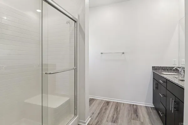 a bathroom with a shower and a sink