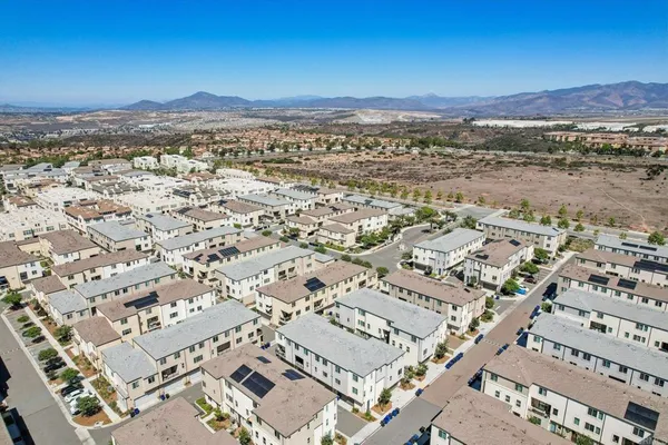 an aerial view of residential building and an ocean