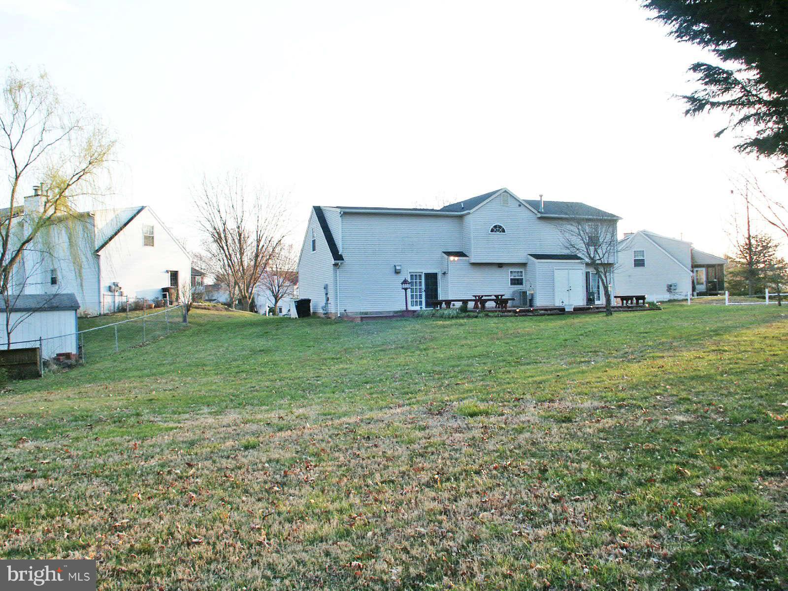 13868 Racine Court Woodbridge, VA 22193 - Photo 21 of 29 a view of a house with a big yard and large tree