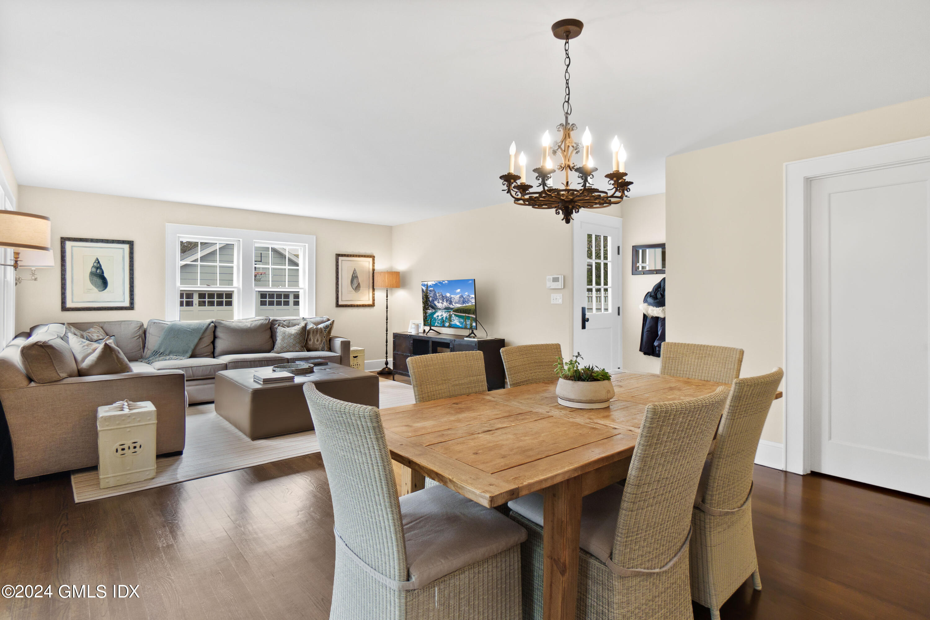20 Knoll Street Riverside, CT 06878 - Photo 12 of 27 a living room with dining table furniture a chandelier and a large mirror