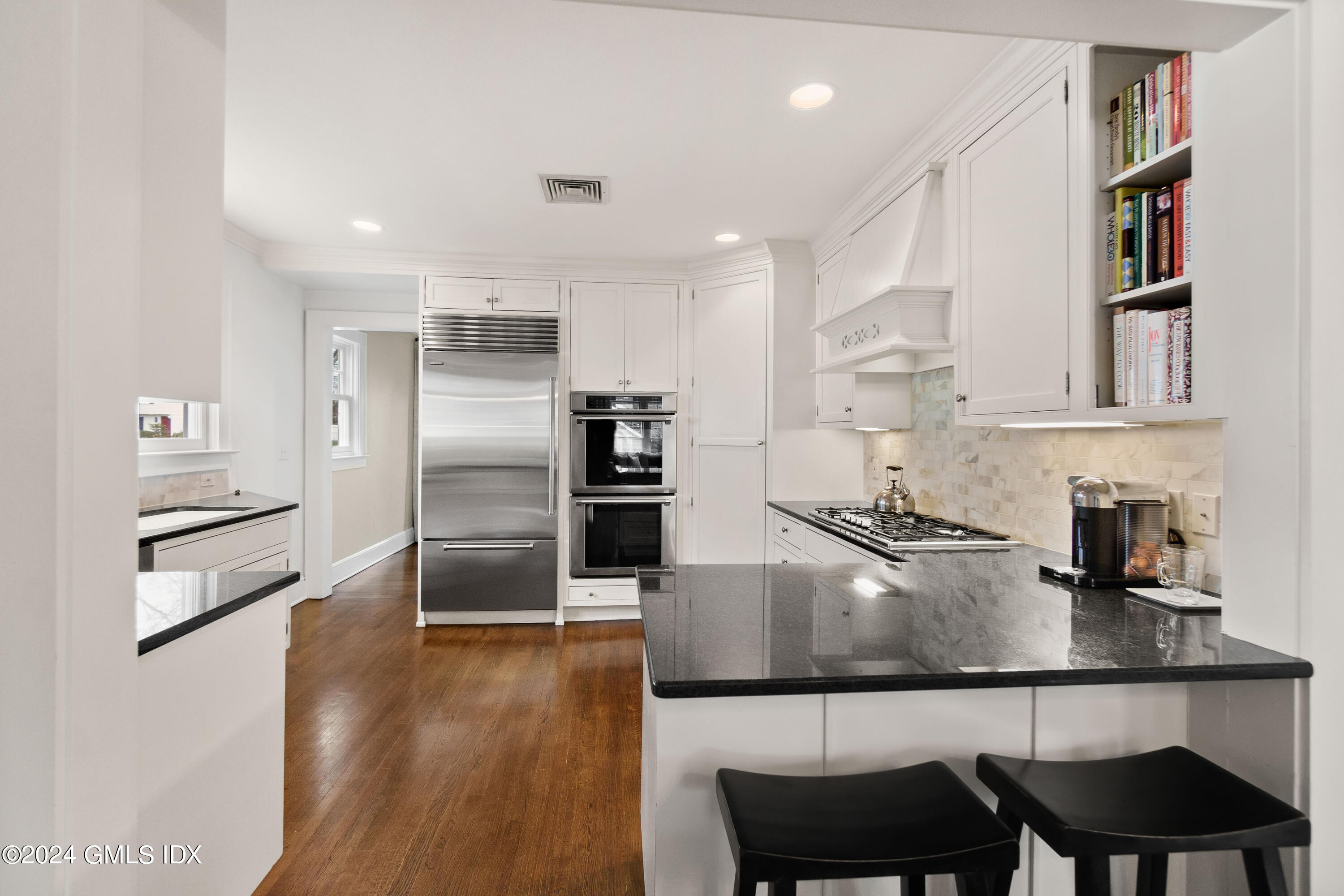 20 Knoll Street Riverside, CT 06878 - Photo 10 of 27 a kitchen with stainless steel appliances granite countertop a refrigerator a sink a stove and white cabinets