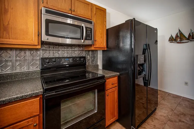 a kitchen with stainless steel appliances a refrigerator and a stove top oven