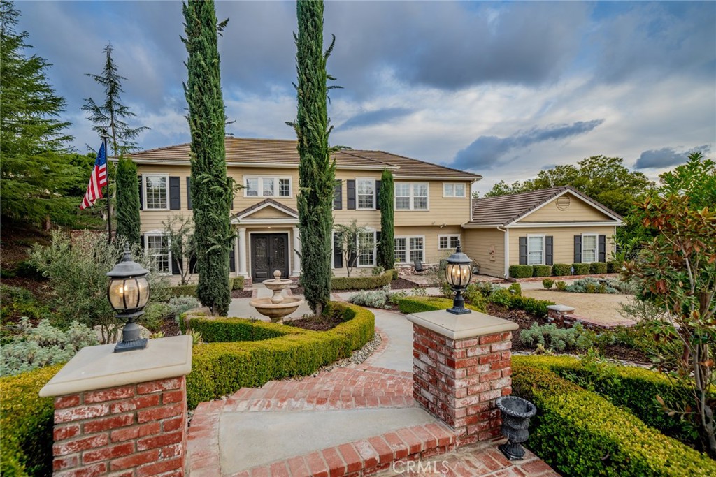 a front view of a house with garden and patio