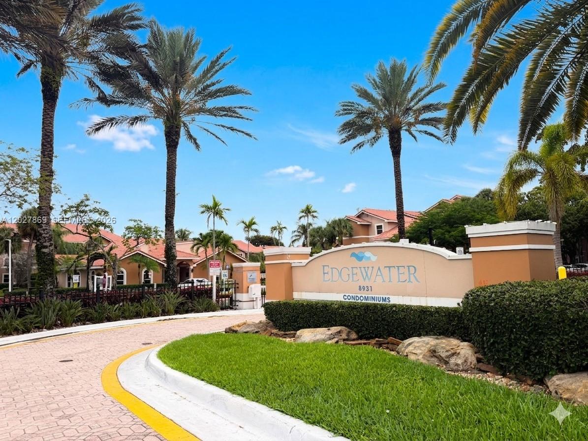 8761 Wiles Road, Unit 206 Coral Springs, FL 33067 - Photo 1 of 26 a swimming pool with outdoor seating and yard