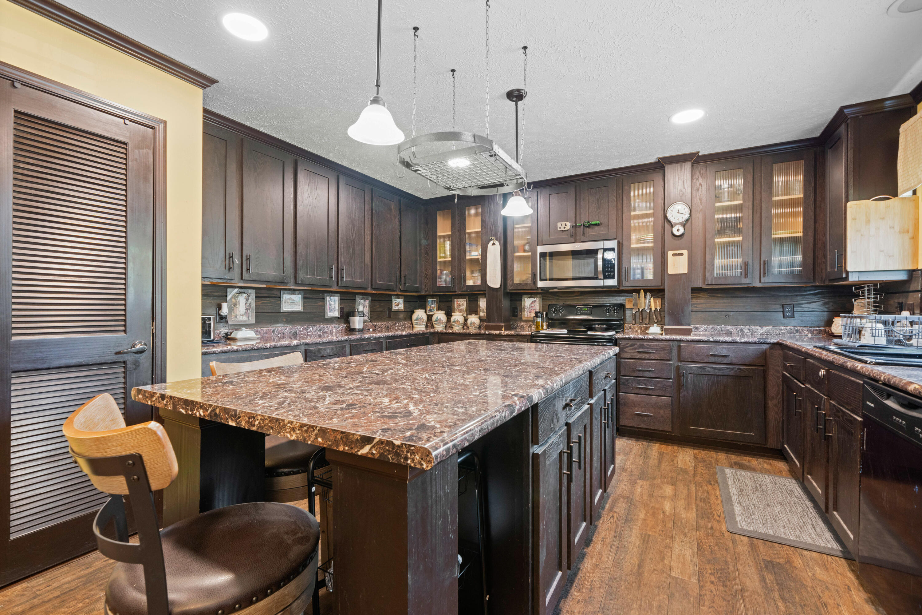8320 Thames Road Baker, FL 32531 - Photo 22 of 48 a kitchen with stainless steel appliances granite countertop a stove refrigerator and cabinets