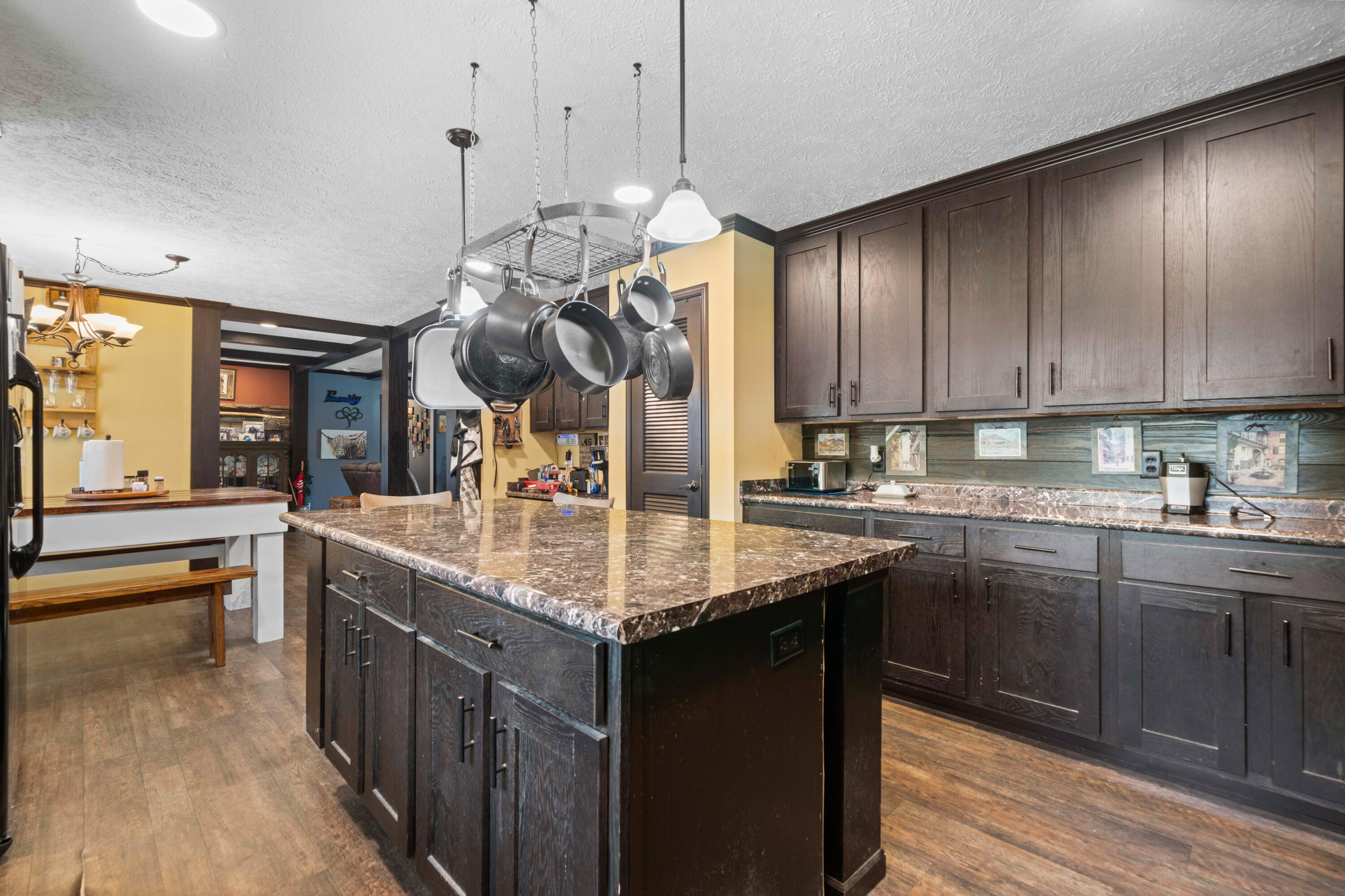 8320 Thames Road Baker, FL 32531 - Photo 24 of 48 a kitchen with kitchen island granite countertop a sink cabinets and wooden floor