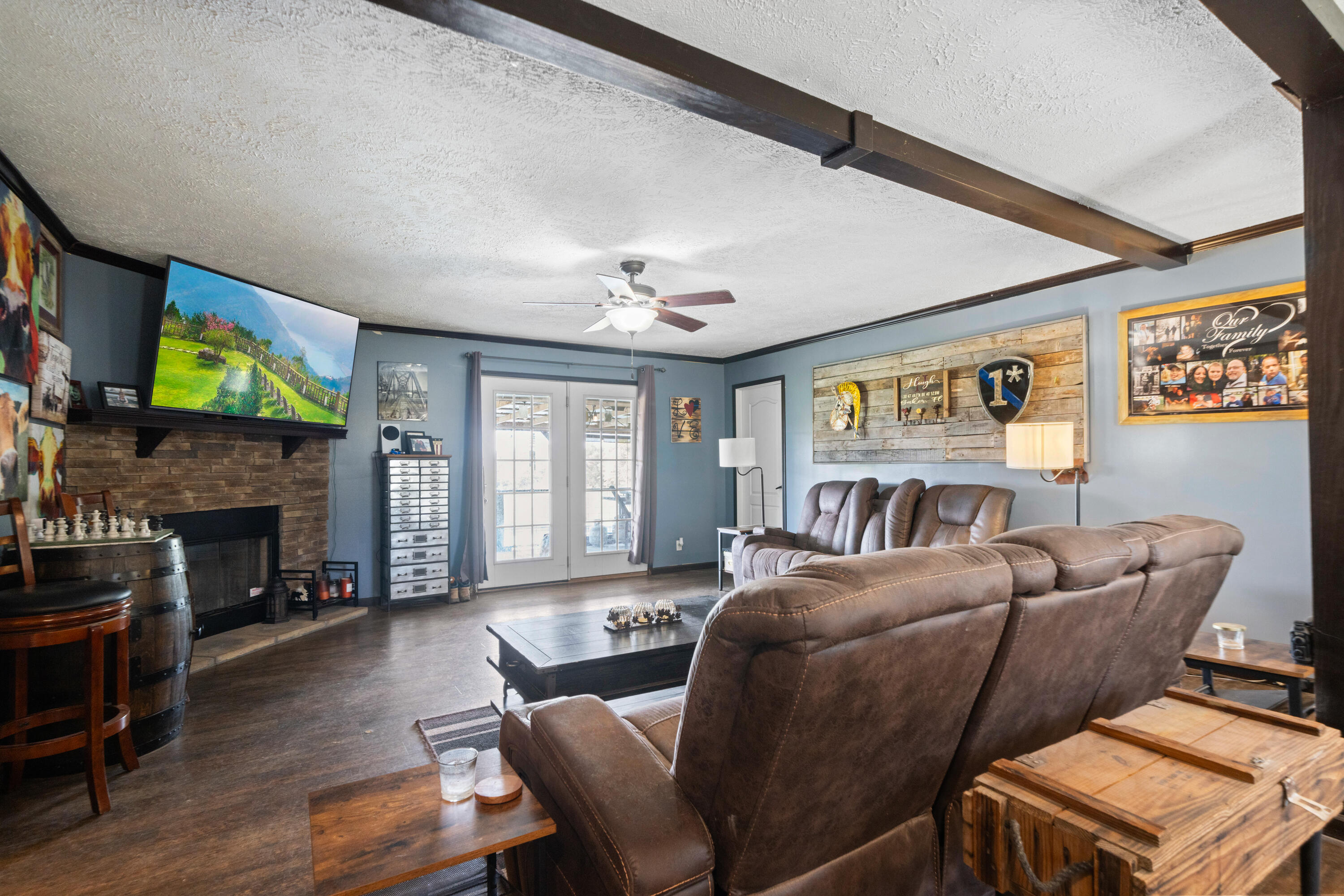 8320 Thames Road Baker, FL 32531 - Photo 27 of 48 a living room with furniture a fireplace and a flat screen tv