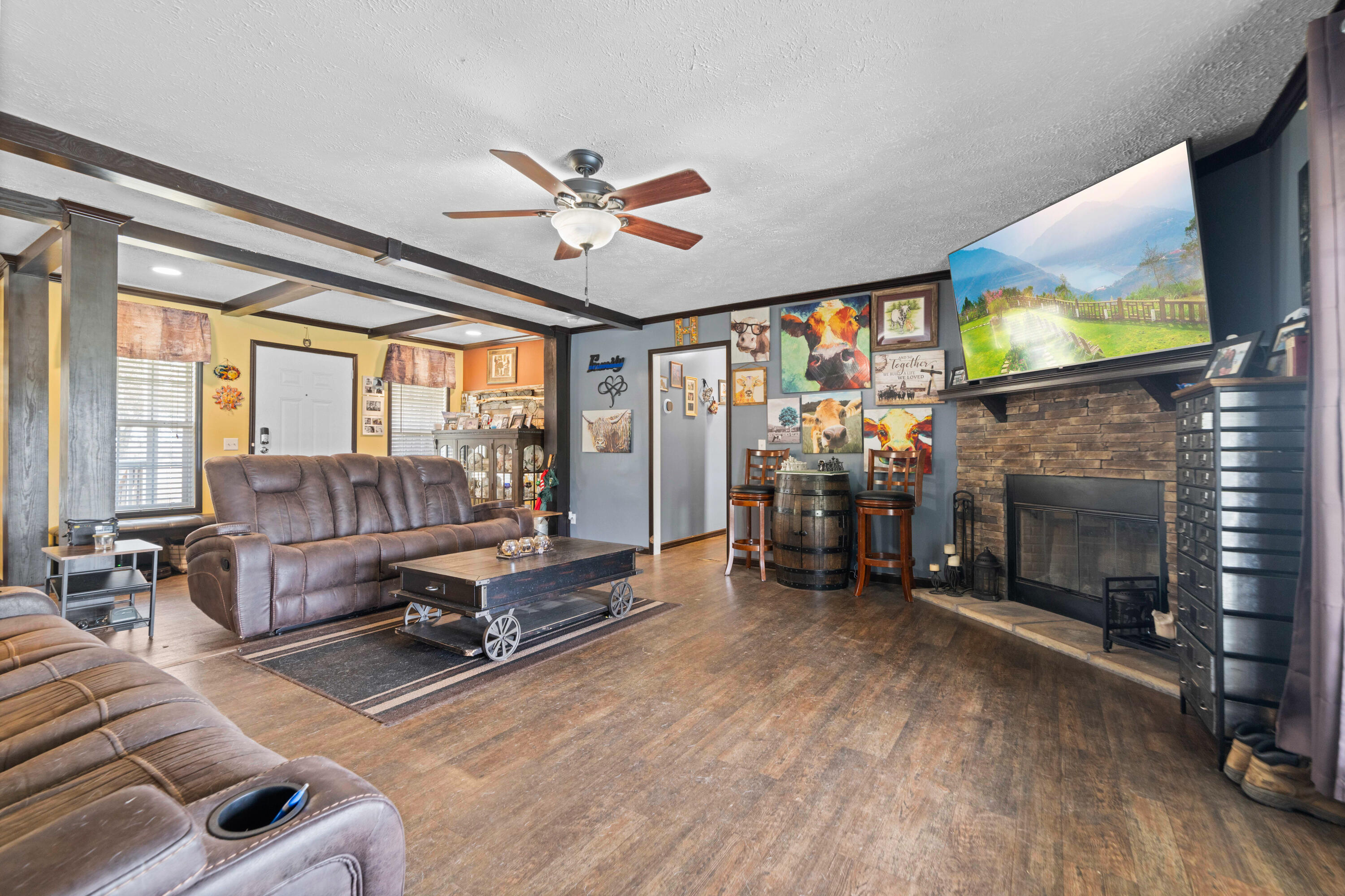 8320 Thames Road Baker, FL 32531 - Photo 28 of 48 a living room with furniture a fireplace and a flat screen tv