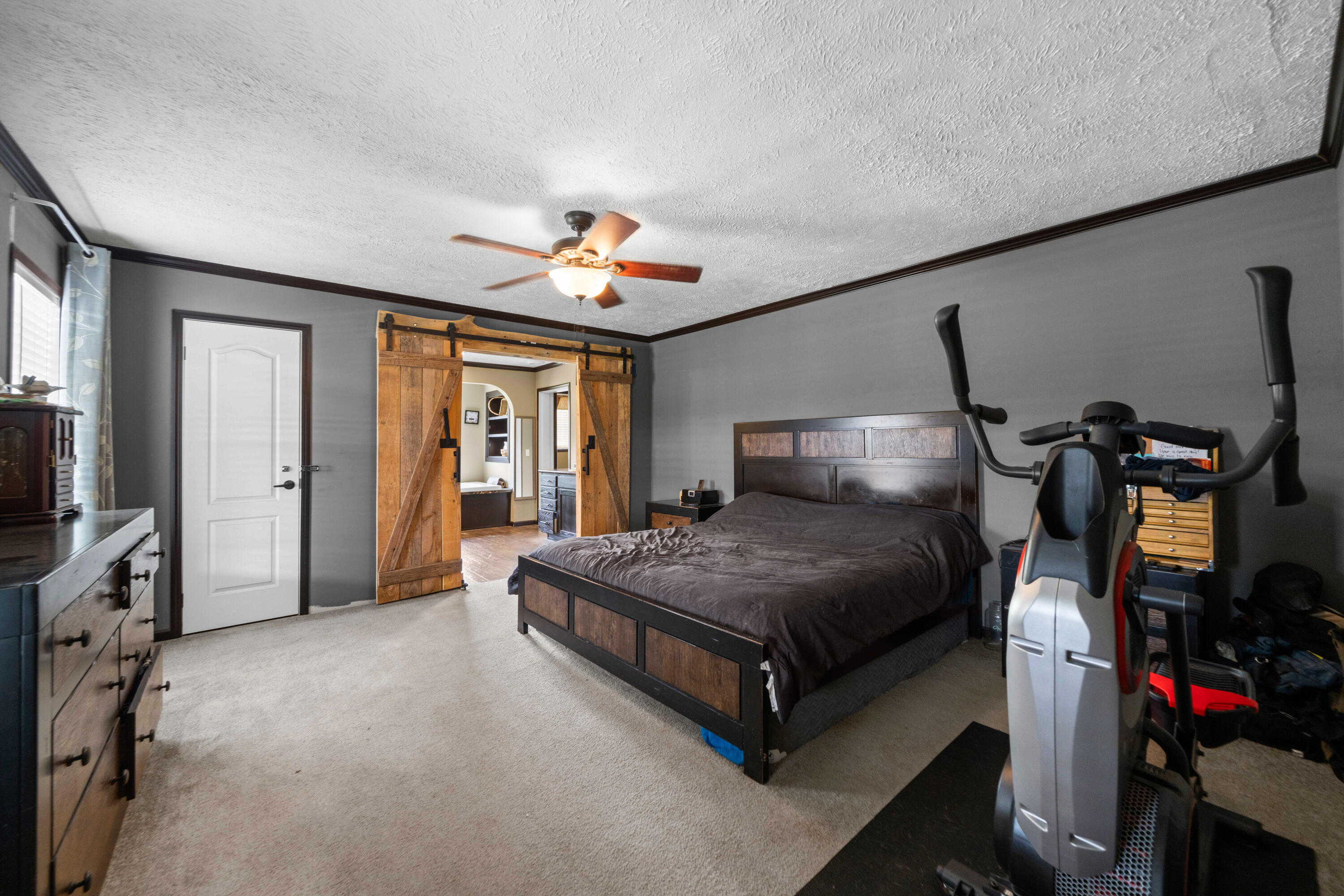 8320 Thames Road Baker, FL 32531 - Photo 30 of 48 a spacious bedroom with a bed and a flat tv screen on the dresser