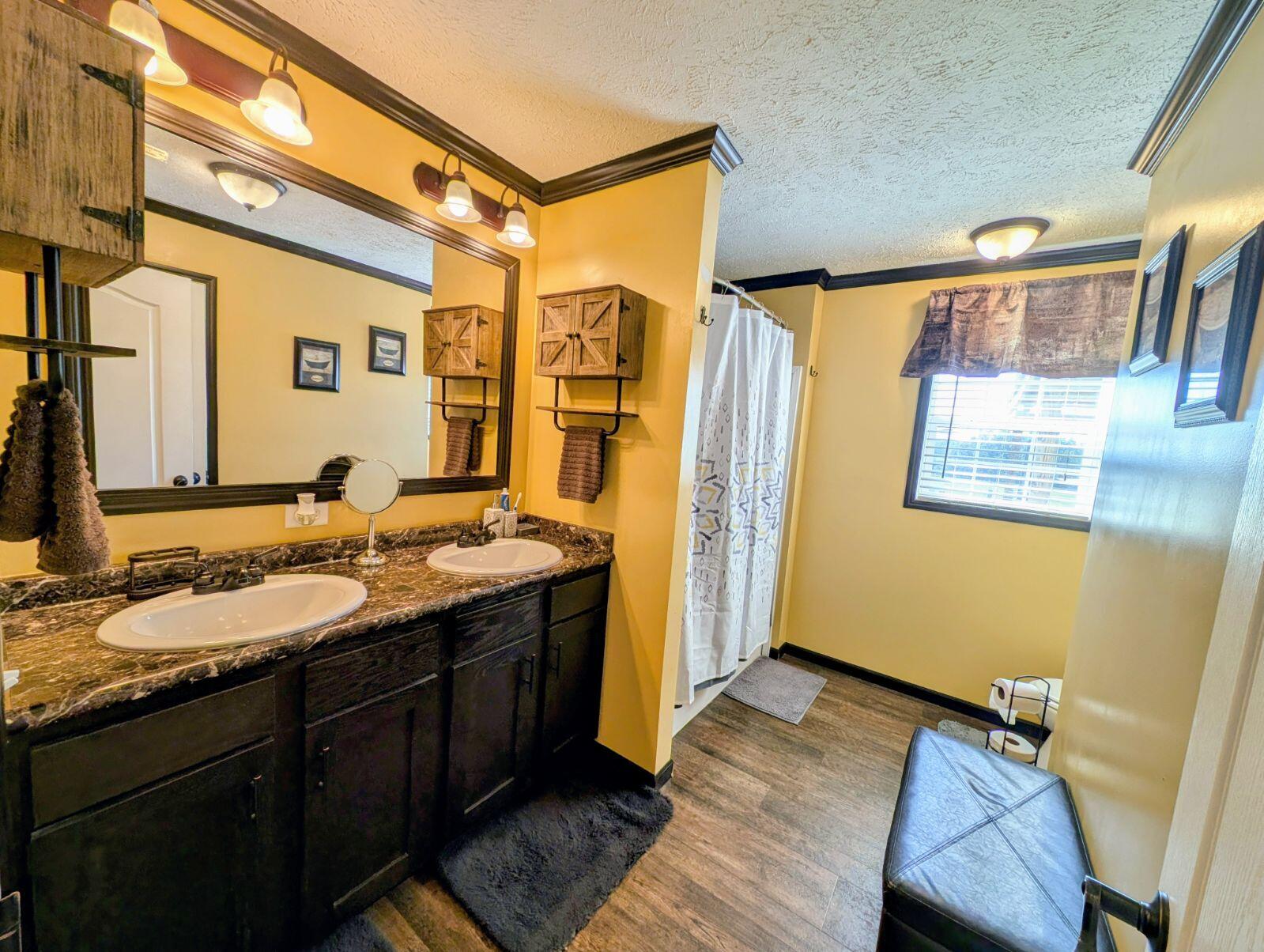 8320 Thames Road Baker, FL 32531 - Photo 38 of 48 a spacious bathroom with a granite countertop sink and a mirror