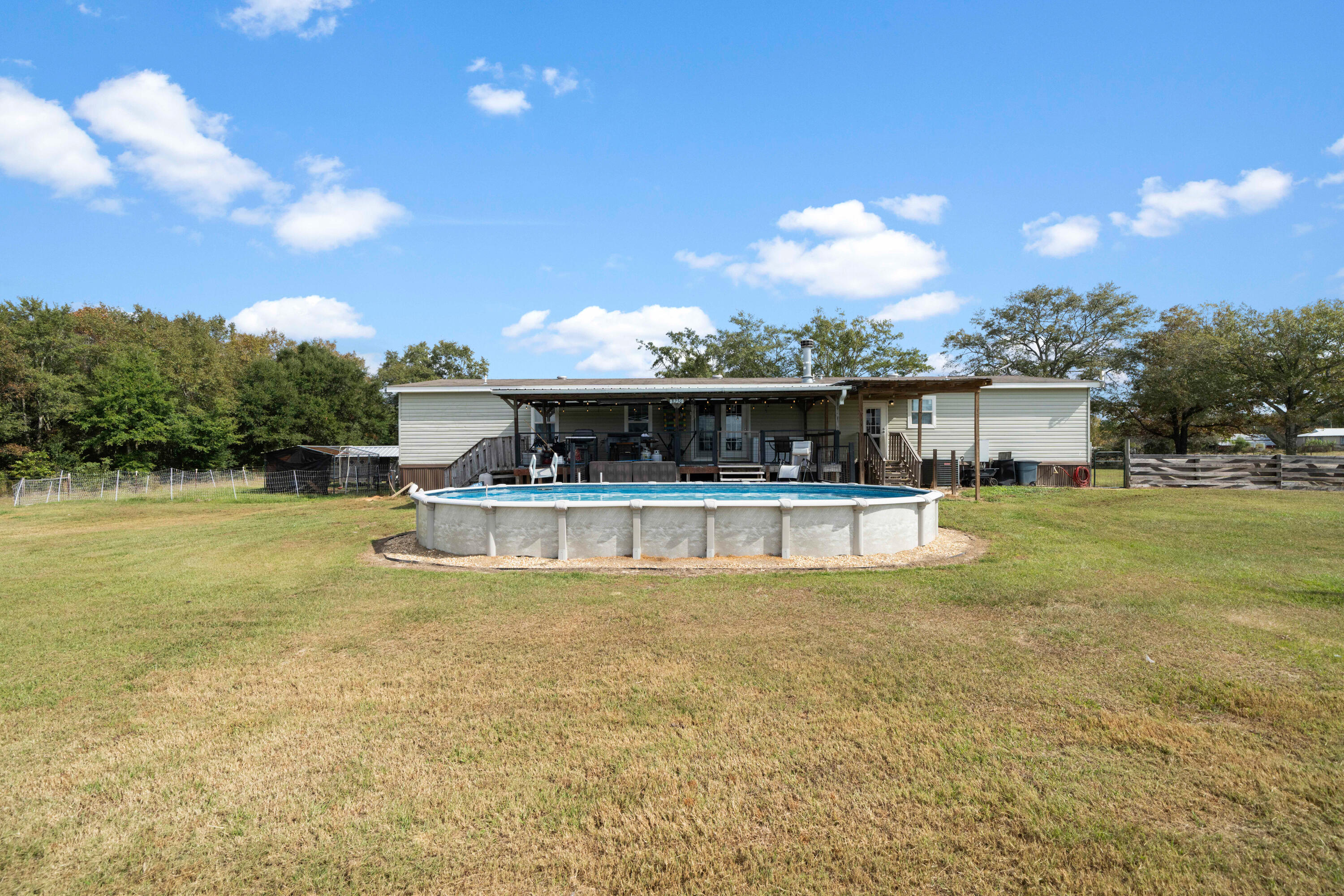 8320 Thames Road Baker, FL 32531 - Photo 42 of 48 a view of a house with swimming pool and a yard