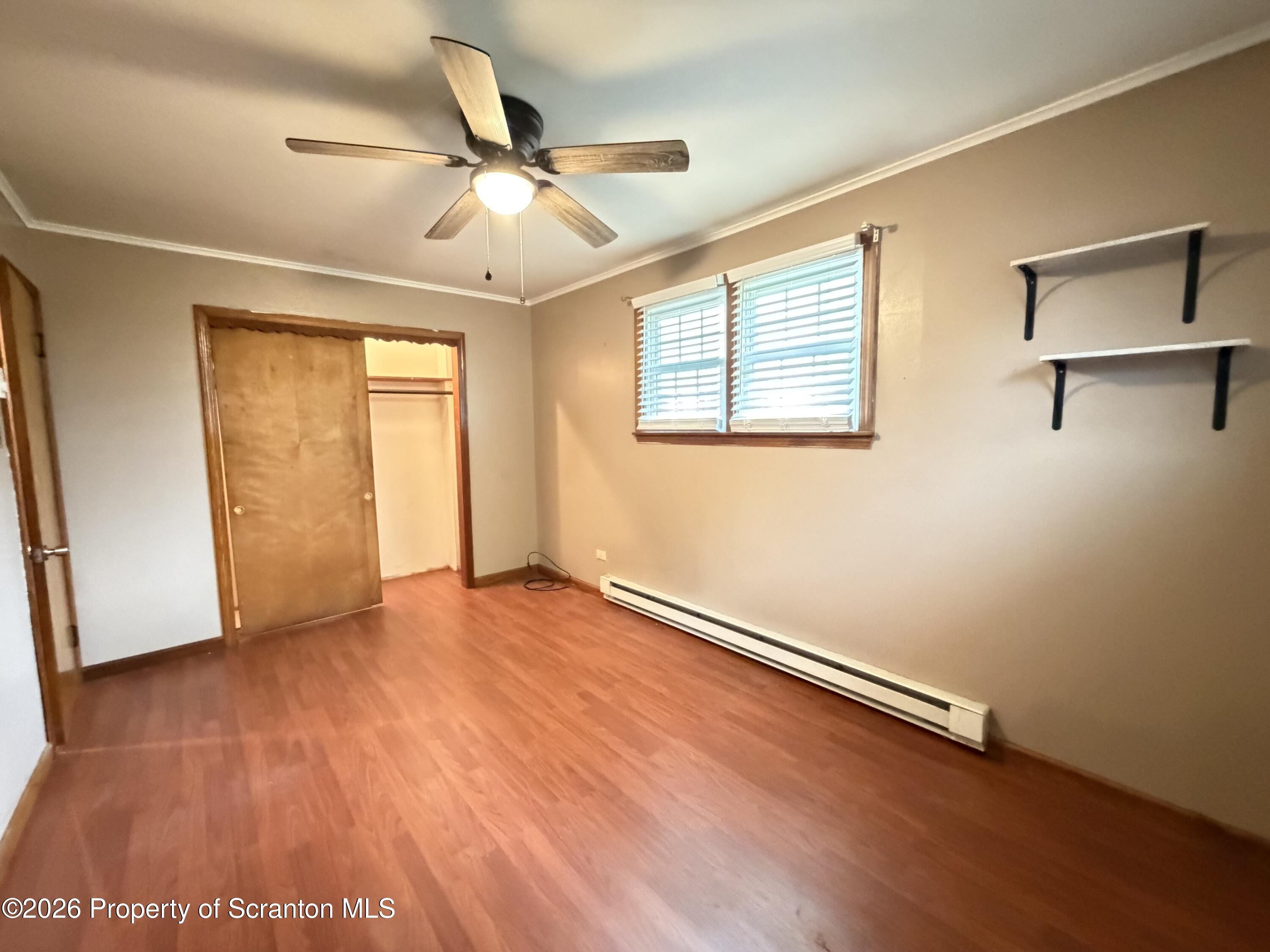 1019 Moosic Street Scranton, PA 18505 - Photo 28 of 43 an empty room with wooden floor fan and windows