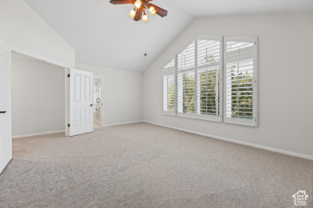 10664 Trail Ridge Circle Sandy, UT 84092 - Photo 28 of 113 Vaulted ceiling with a wood-finish ceiling fan, expansive window with plantation shutters, light gray carpet, and white paneled doors