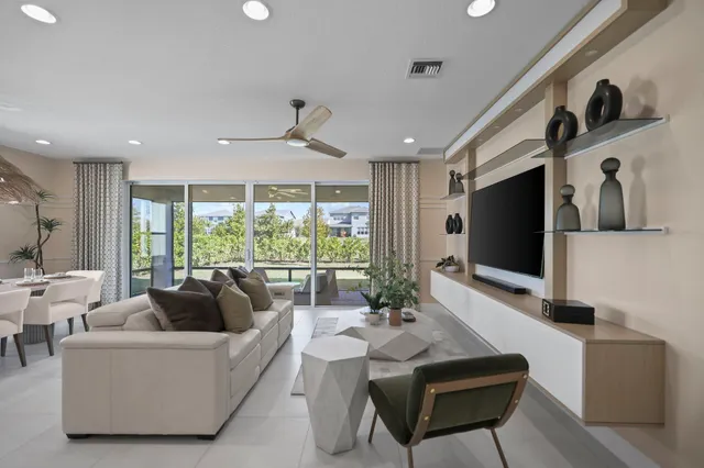 a living room with furniture tv and a large window