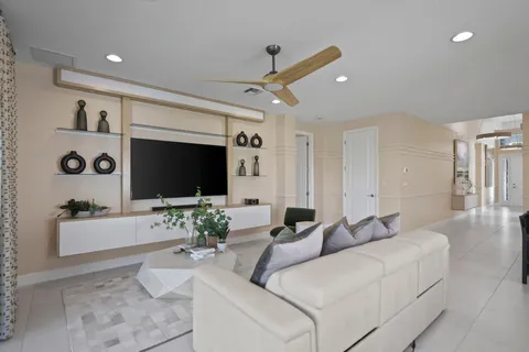 a view of a dining room and livingroom with furniture wooden floor a chandelier