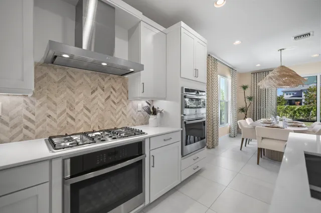 a kitchen with cabinets and stainless steel appliances