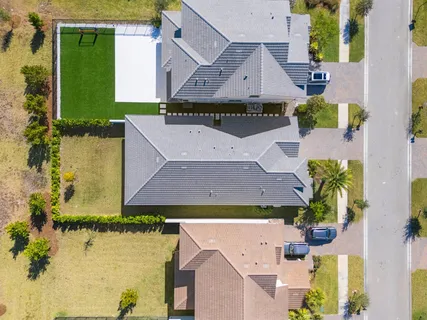 an aerial view of residential houses with outdoor space