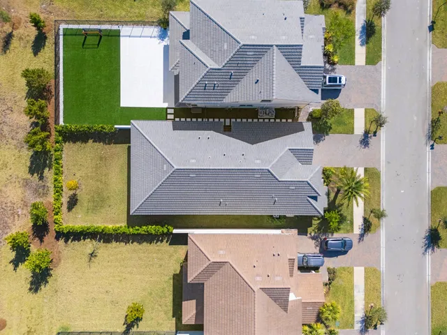 an aerial view of residential houses with outdoor space