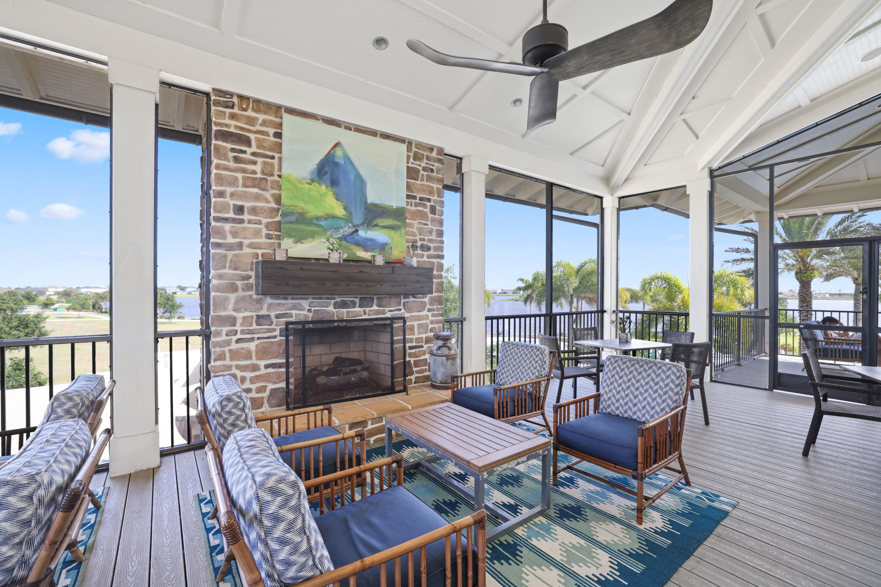 19545 Broad Shore Walk Loxahatchee, FL 33470 - Photo 57 of 65 a living room with furniture a fireplace and a floor to ceiling window