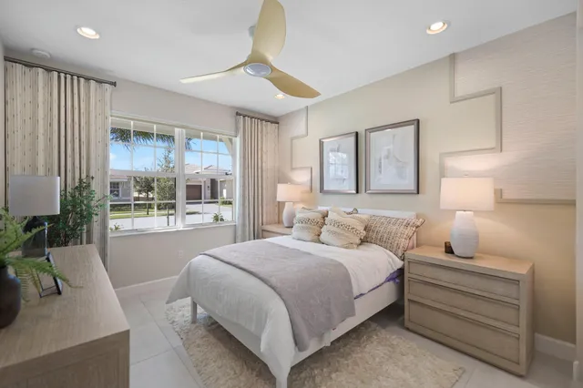 a bedroom with a large bed and a large window