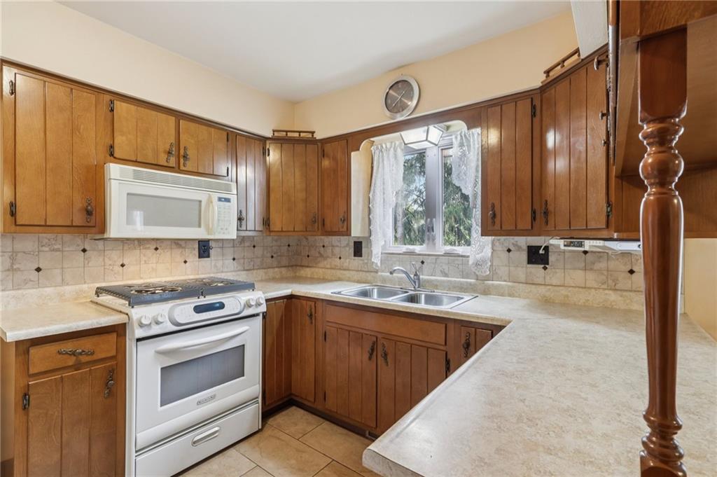 957 Cherry Lane Road Apollo, PA 15613 - Photo 11 of 38 a kitchen with stainless steel appliances granite countertop a sink stove and cabinets