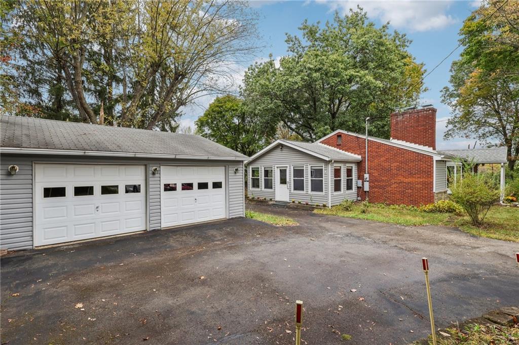 957 Cherry Lane Road Apollo, PA 15613 - Photo 30 of 38 a front view of a house with a yard and garage