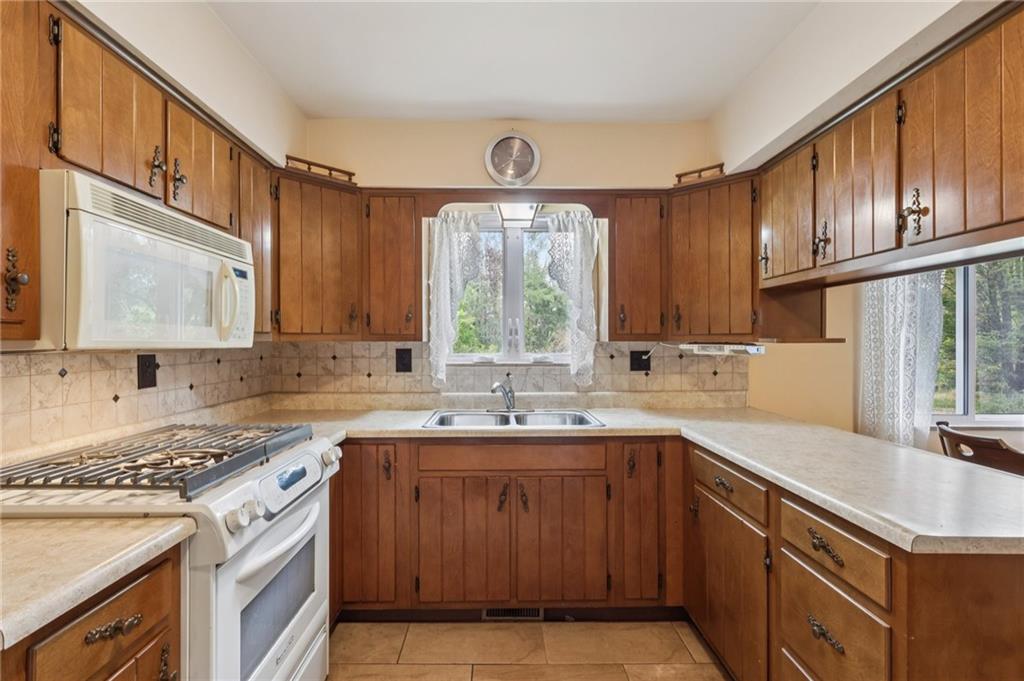 957 Cherry Lane Road Apollo, PA 15613 - Photo 10 of 38 a kitchen with a sink stove top oven and cabinets