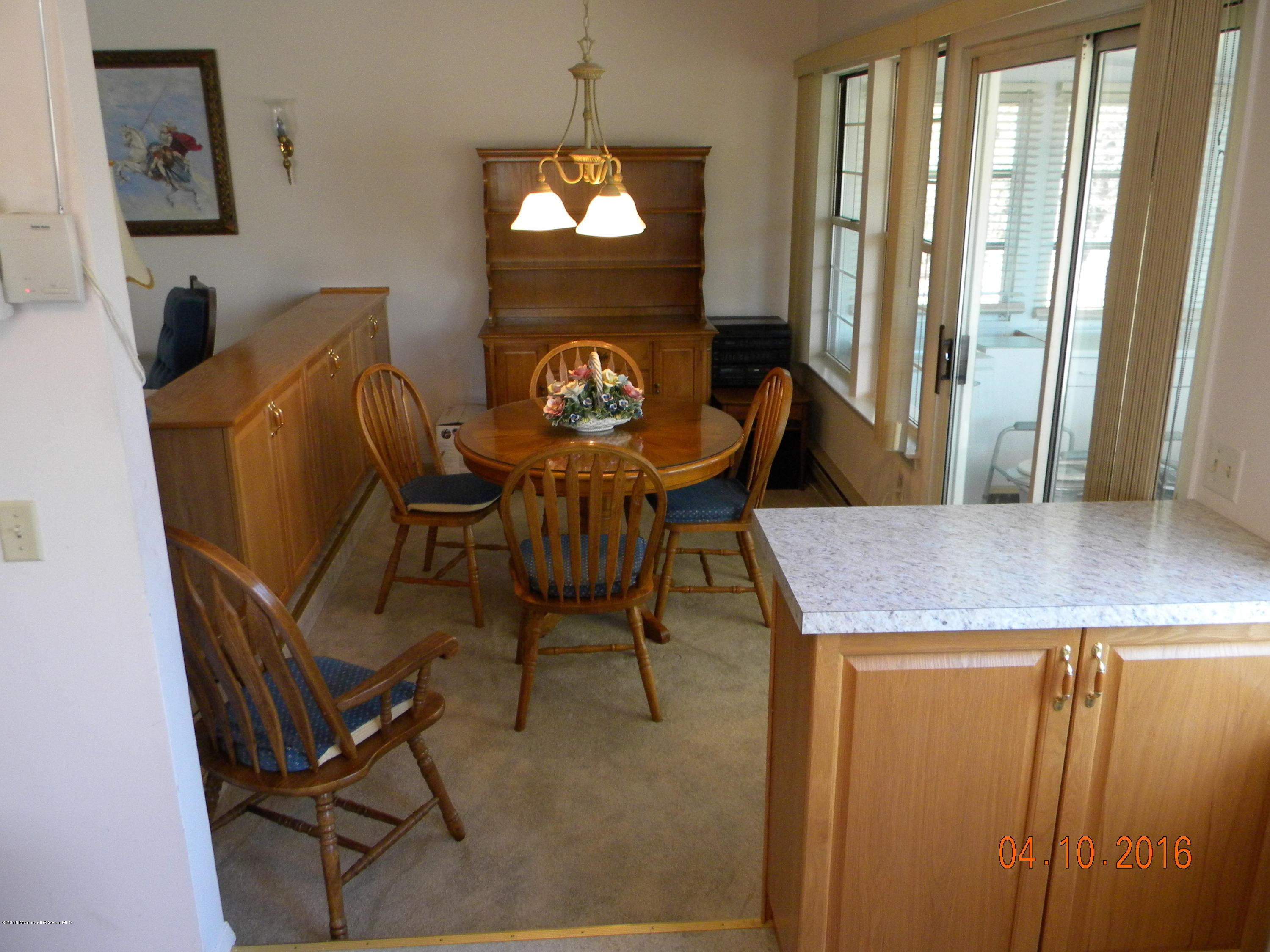 34A Ashley Road, Unit D Whiting, NJ 08759 - Photo 13 of 35 a view of a dining room with furniture and a chandelier