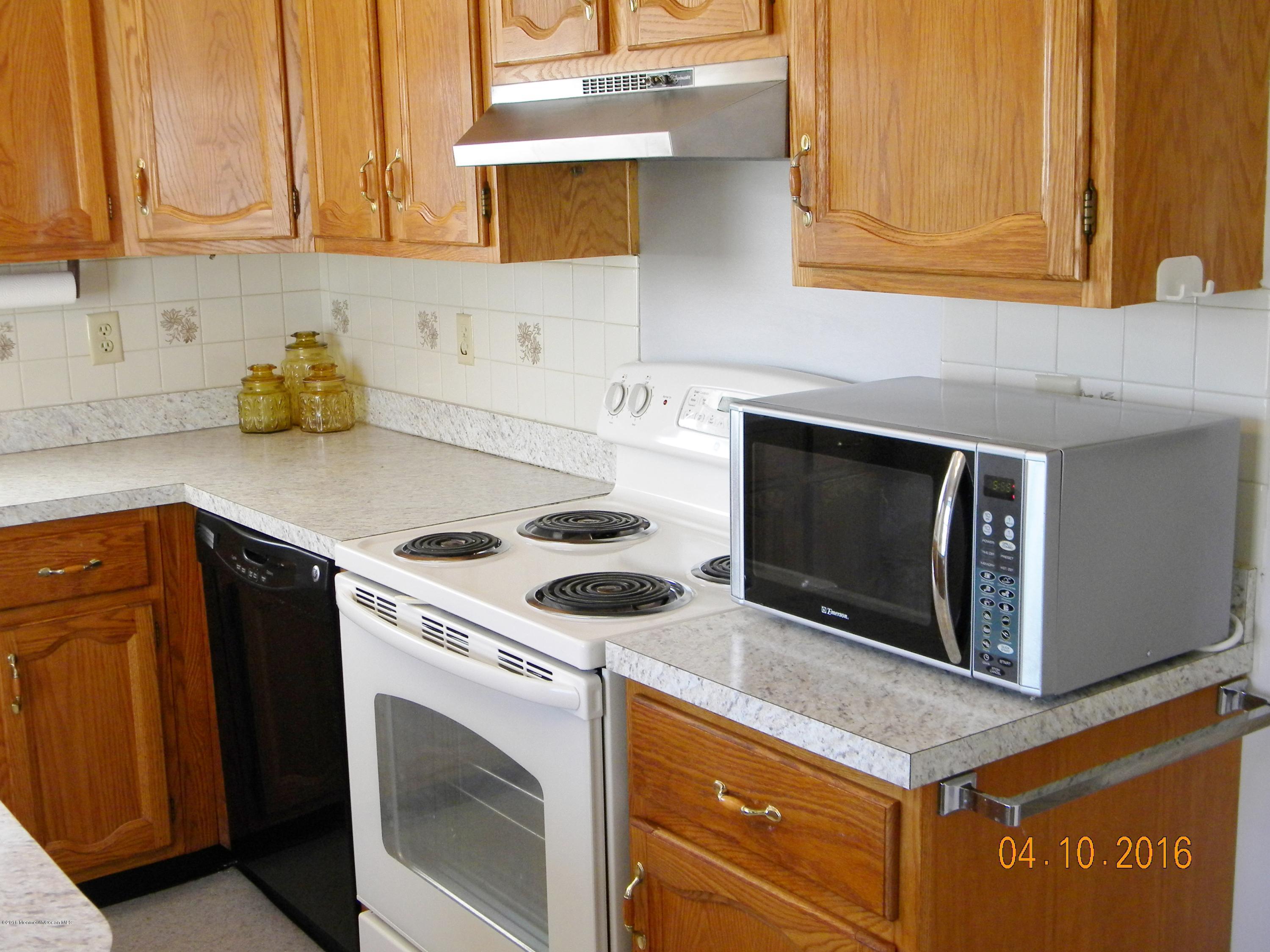34A Ashley Road, Unit D Whiting, NJ 08759 - Photo 15 of 35 a kitchen with stainless steel appliances granite countertop a stove microwave and sink
