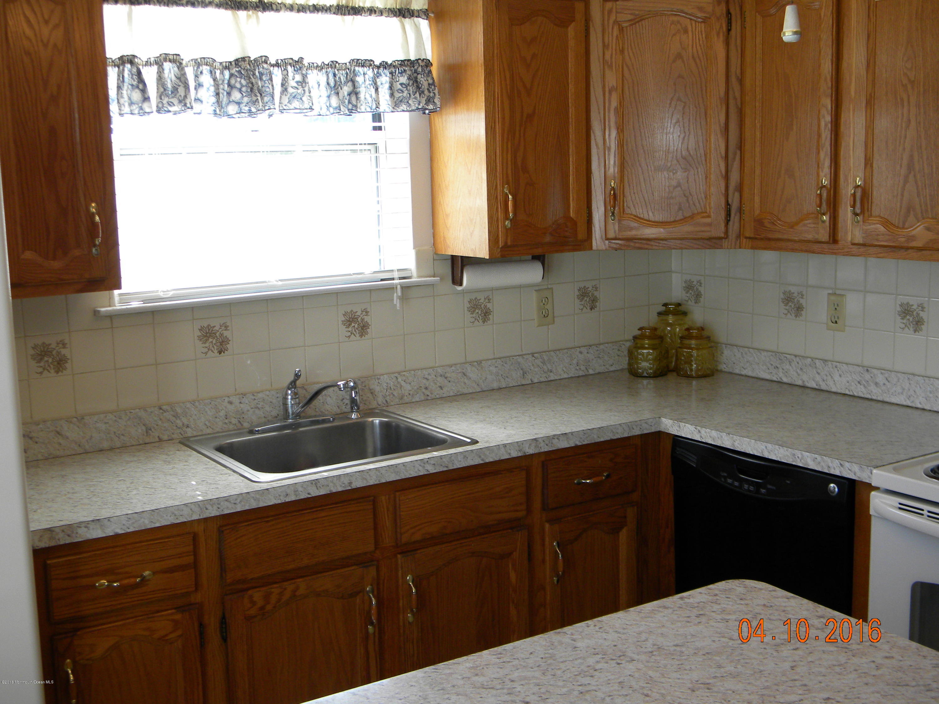 34A Ashley Road, Unit D Whiting, NJ 08759 - Photo 16 of 35 a kitchen with a sink and cabinets