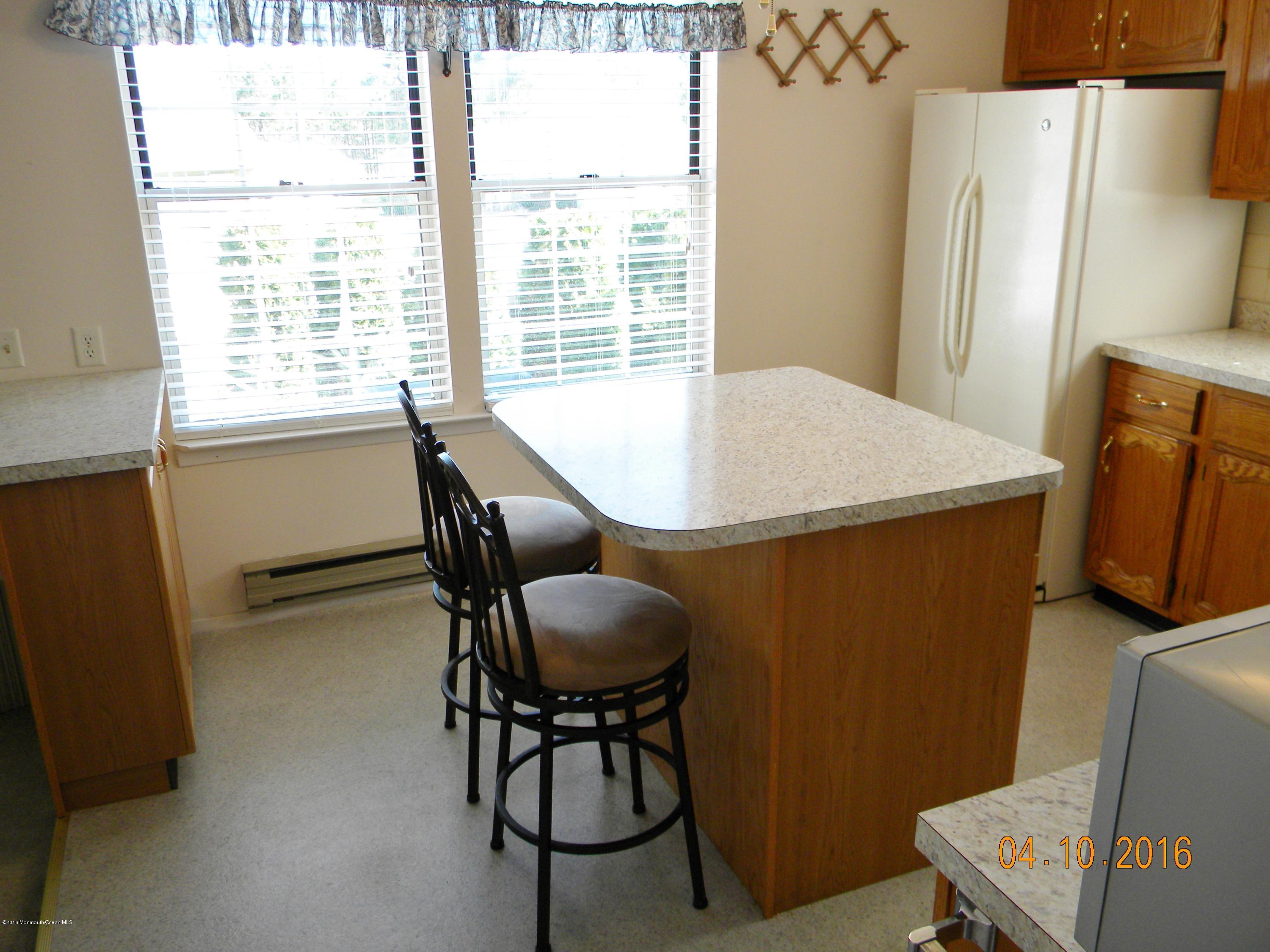 34A Ashley Road, Unit D Whiting, NJ 08759 - Photo 17 of 35 a dining room with furniture and a window