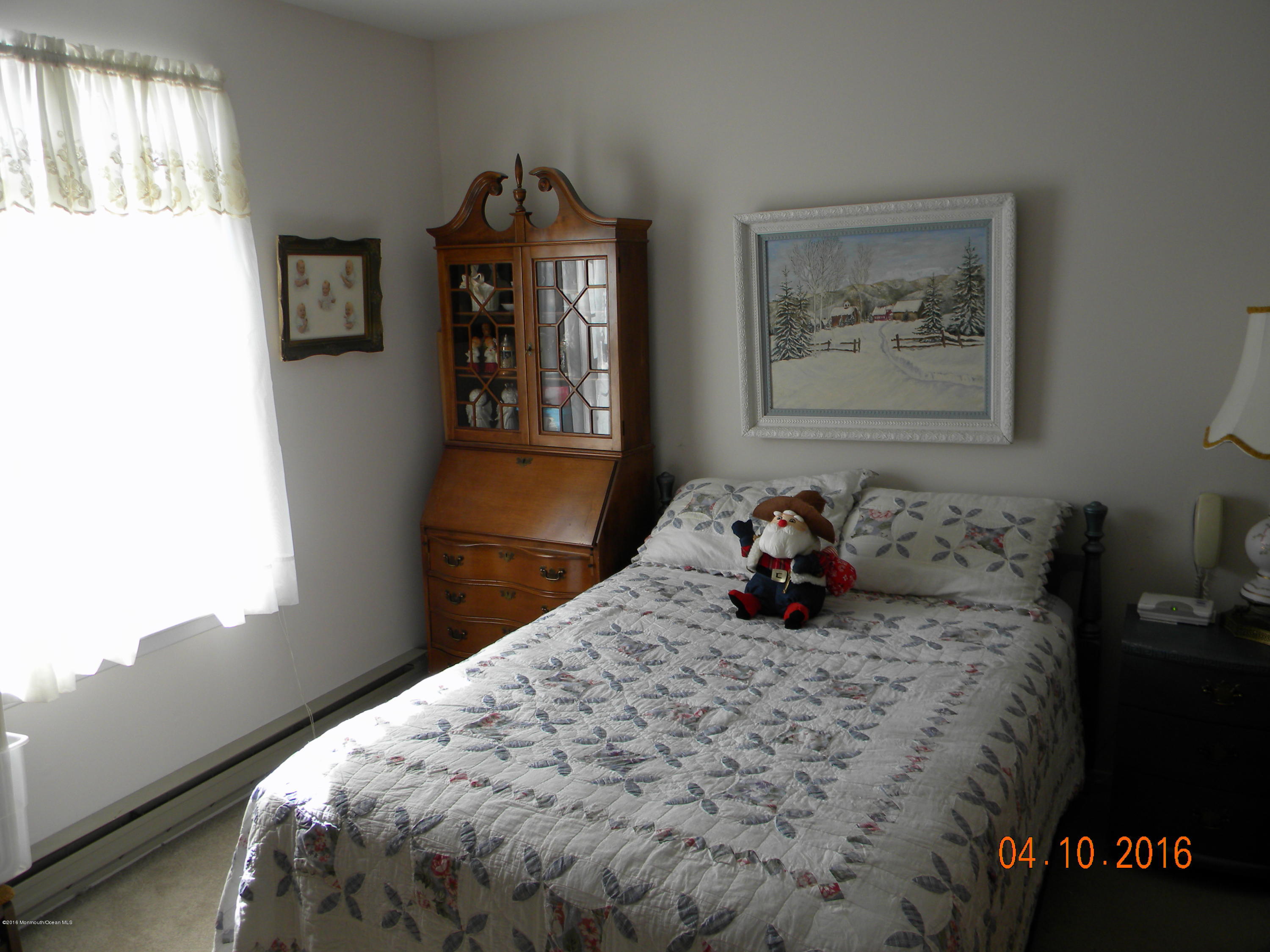 34A Ashley Road, Unit D Whiting, NJ 08759 - Photo 26 of 35 a bed sitting in a bedroom next to a window
