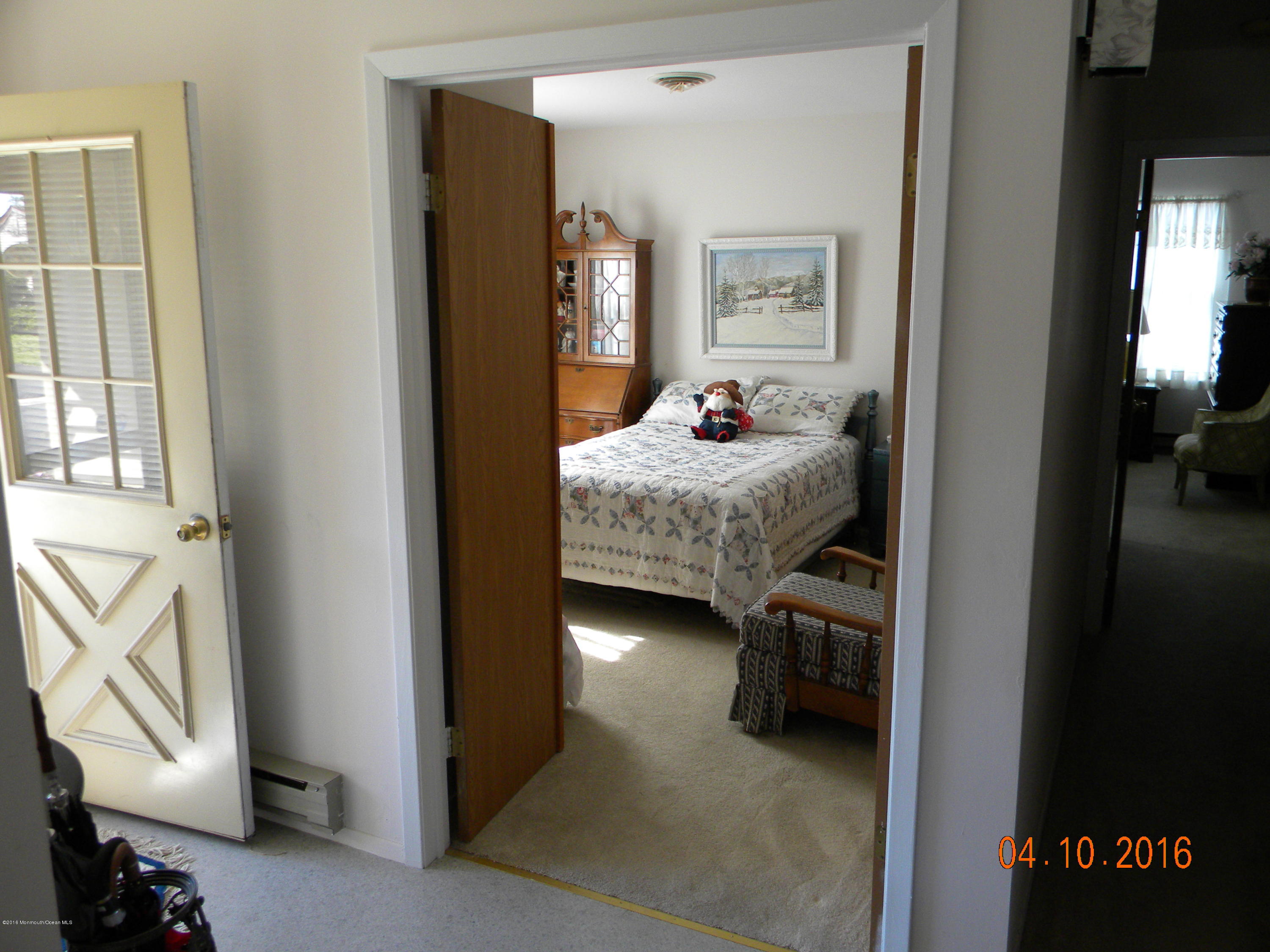 34A Ashley Road, Unit D Whiting, NJ 08759 - Photo 27 of 35 a bedroom with a bed and a chandelier