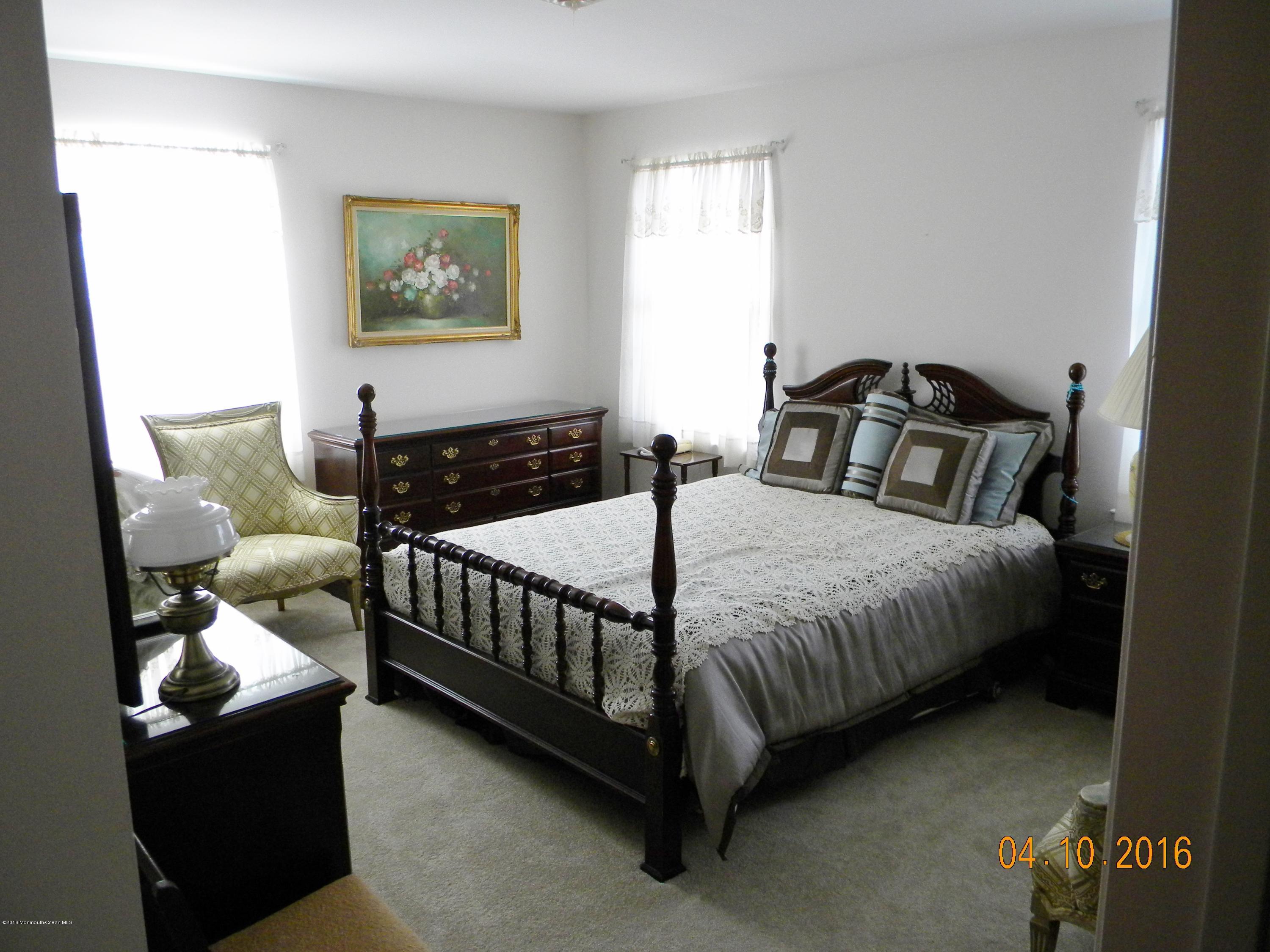 34A Ashley Road, Unit D Whiting, NJ 08759 - Photo 30 of 35 a bedroom with a bed and a couch