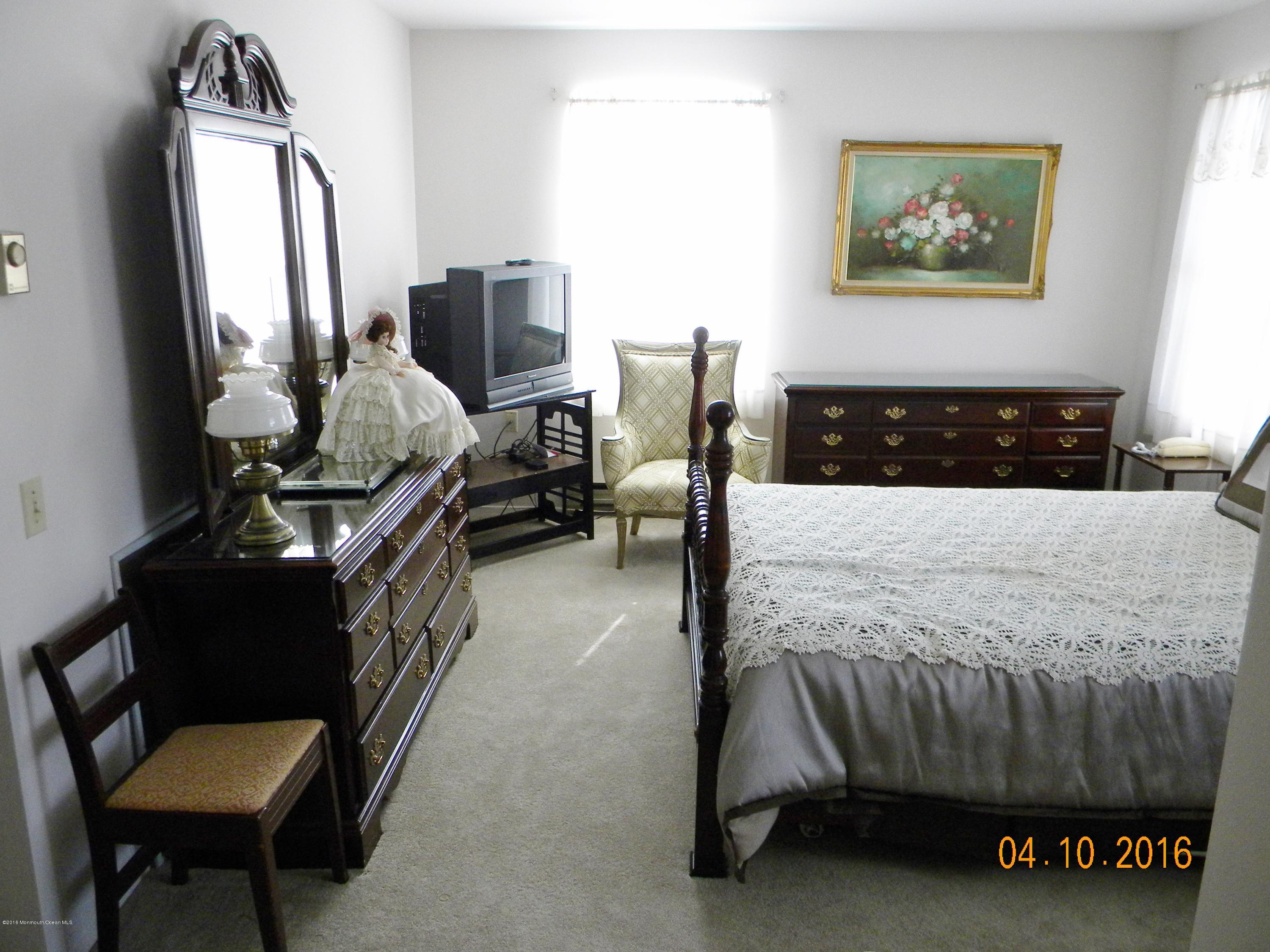 34A Ashley Road, Unit D Whiting, NJ 08759 - Photo 31 of 35 a bedroom with a bed and wooden floor