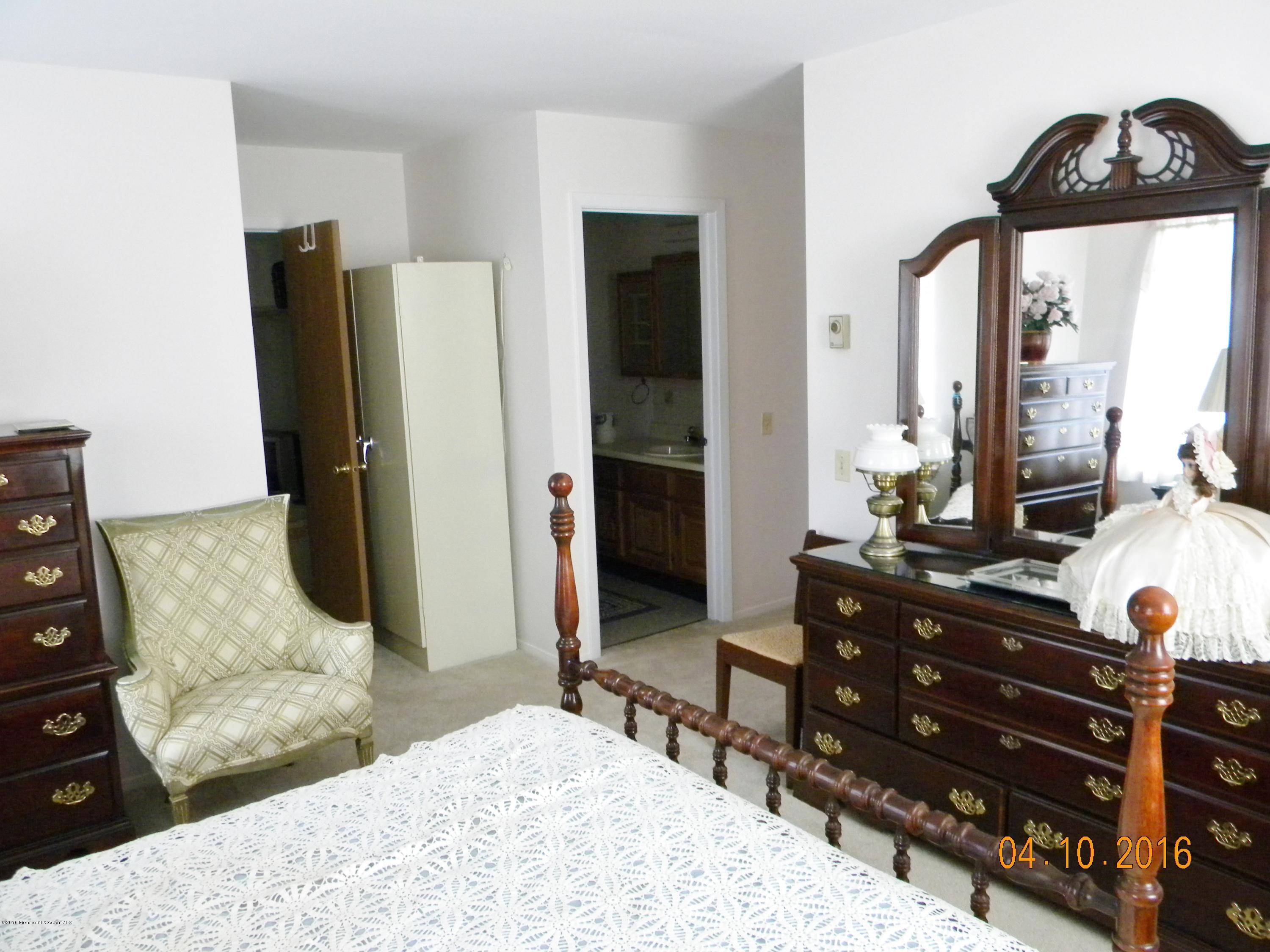 34A Ashley Road, Unit D Whiting, NJ 08759 - Photo 32 of 35 a bedroom with a bed and a dresser in it