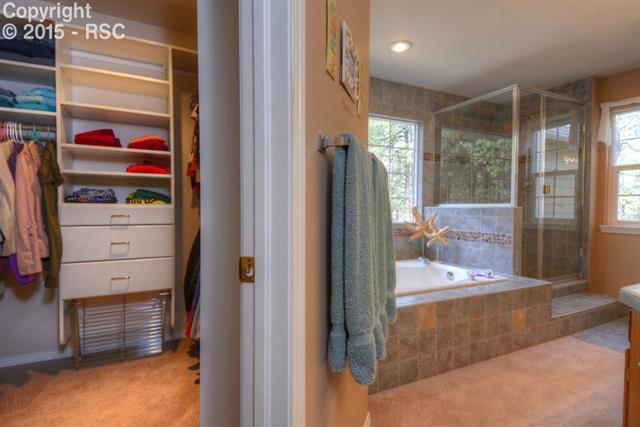 875 Bend In The Trail Road Monument, CO 80132 - Photo 19 of 36 Custom master walk-in closet and 5 piece master bath
