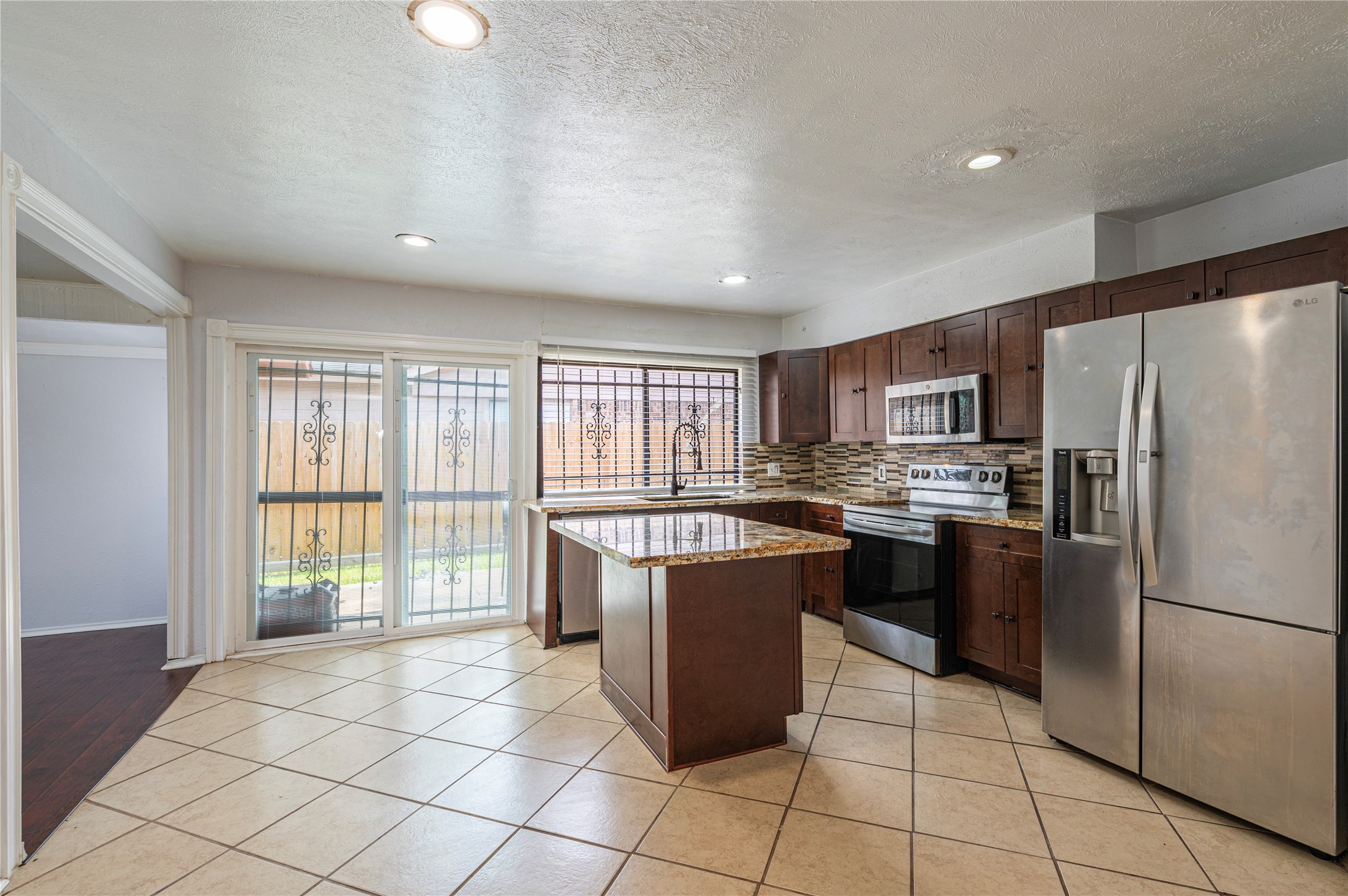 15722 Corsair Road Houston, TX 77053 - Photo 8 of 23 Patio off of the kitchen leads to the backyard